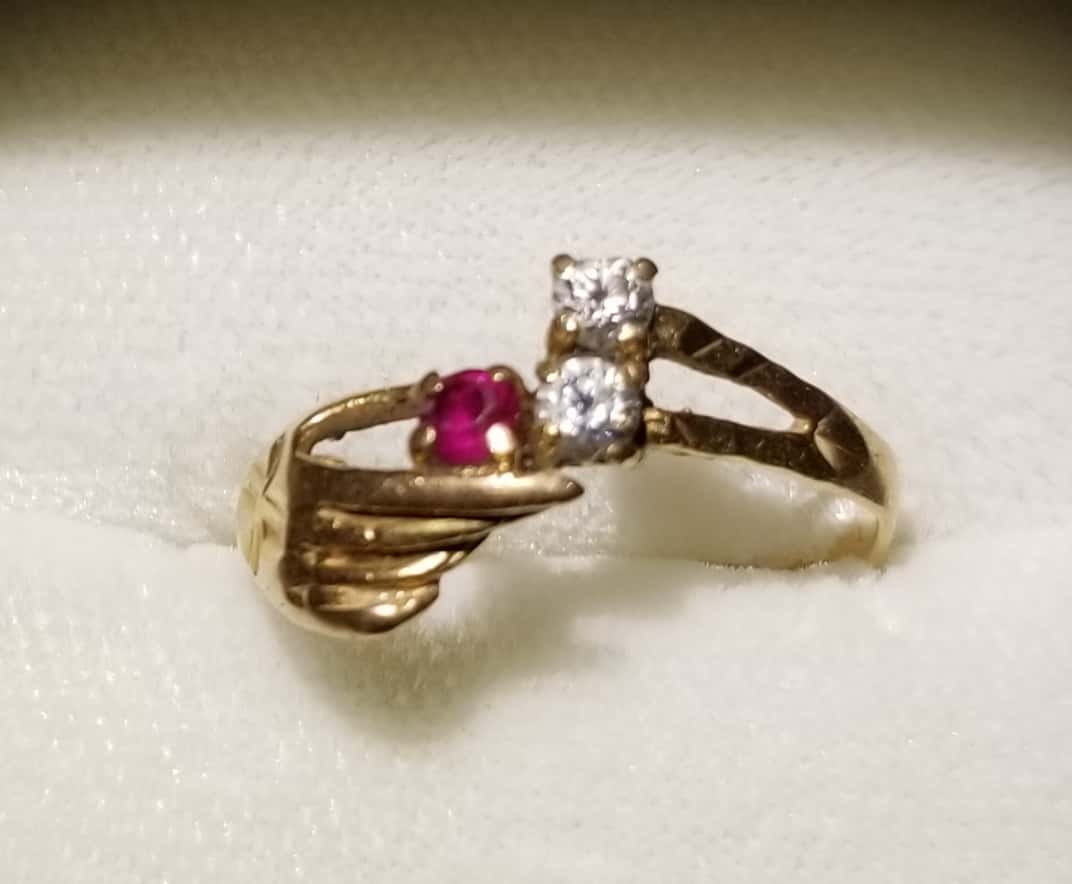 Front View of Ring Setting with Hand Like Shape Holding Ruby Stone and Two Other Diamonds Set on Arrow like Shape