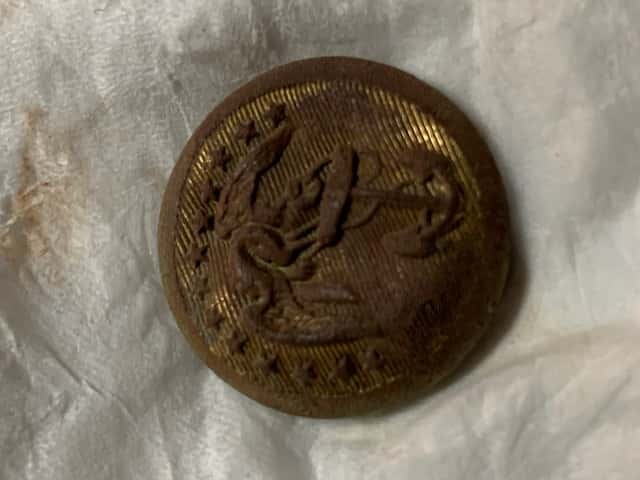 Front of Rusted Button with Eagle Holding Anchor Visible