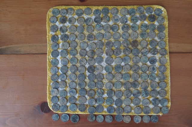 Pennies Arranged in a Grid with Dirt and Oxidation Resting on Yellow Cloth