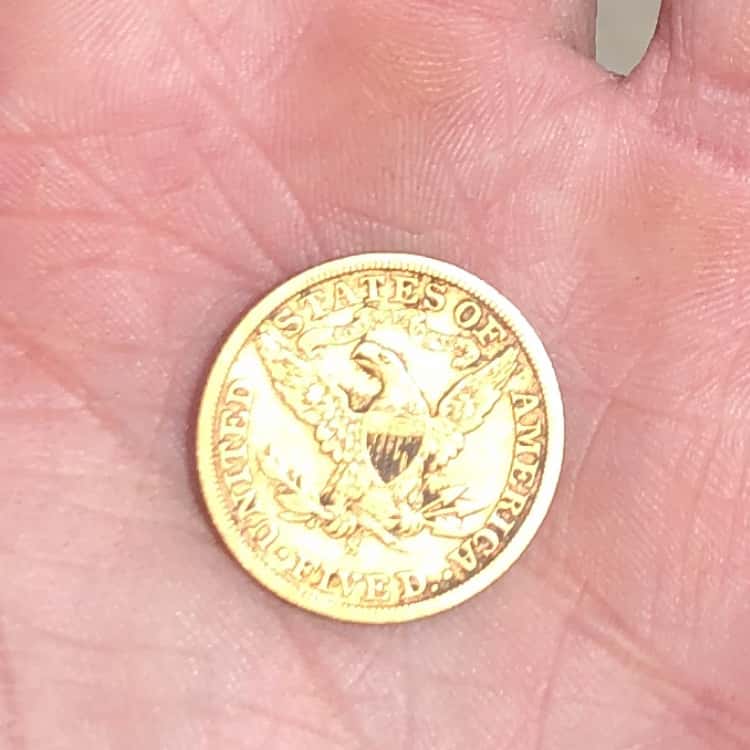Reverse of 1901 Liberty Head Gold Coin Held In Palm with Eagle Visible Clutching Arrows