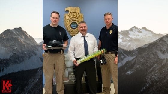Image of David Bachert and Members of the Sevierville Police Department Holding Evidence Collecting Materials In front of Image of Mountains in The Background